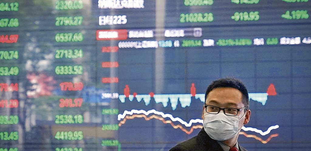 A man wearing a protective mask is seen inside the Shanghai Stock Exchange building, as the country is hit by a new coronavirus outbreak, at the Pudong financial district in Shanghai, China February 28, 2020. REUTERS/Aly Song - RC2Y9F9NSHR6