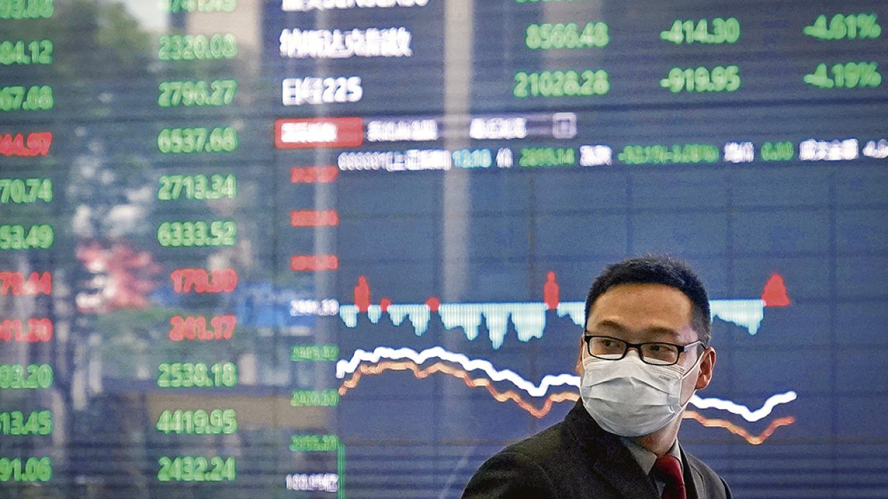 A man wearing a protective mask is seen inside the Shanghai Stock Exchange building, as the country is hit by a new coronavirus outbreak, at the Pudong financial district in Shanghai, China February 28, 2020. REUTERS/Aly Song - RC2Y9F9NSHR6